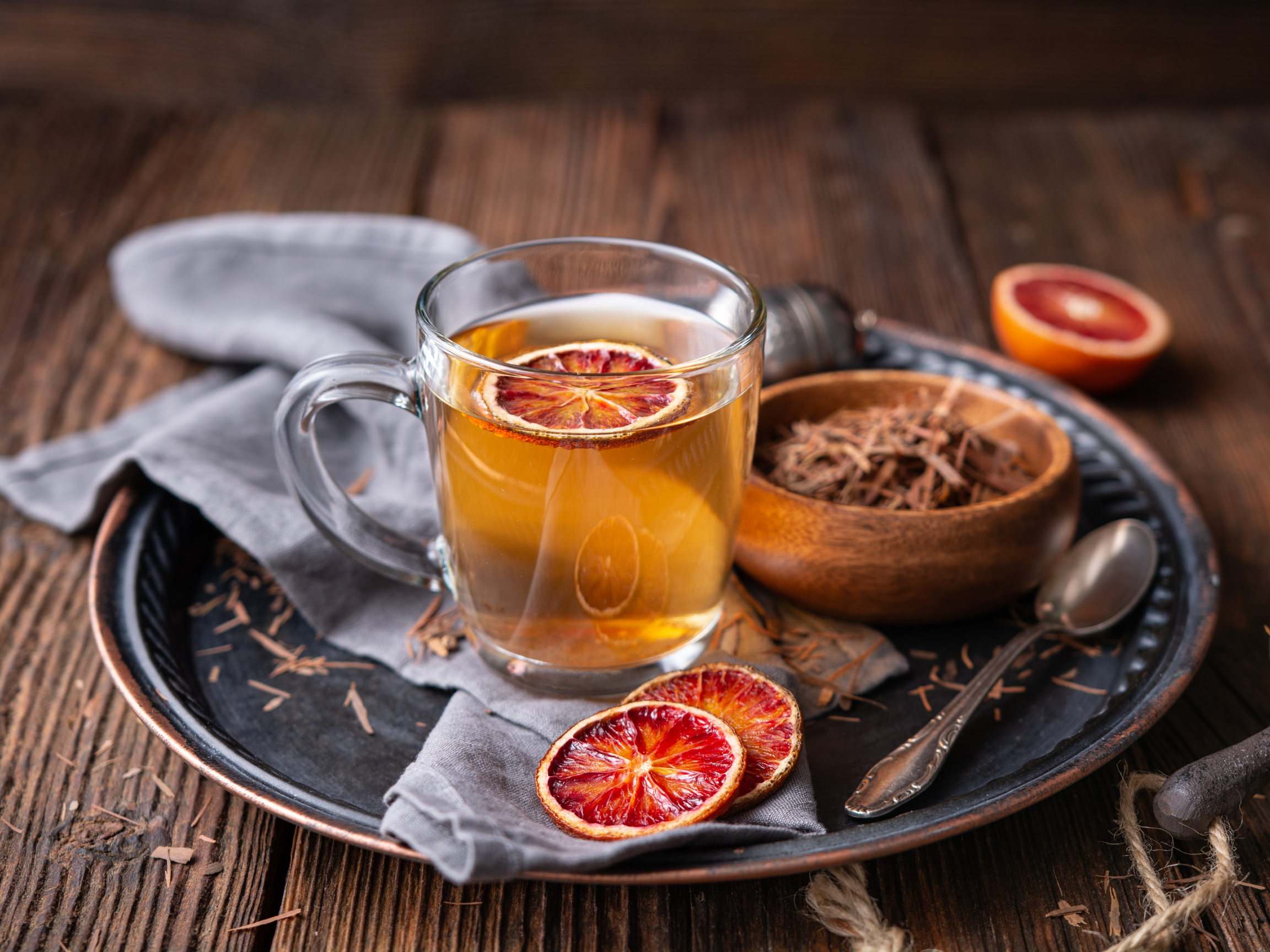 a glass cup filled with medicinal Pau d'Arco bark tea, derived from the lapacho tree, a homeopathic health remedy