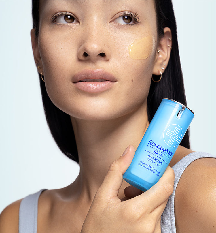 a woman holding the bottle container of RescueMD serum in her hands, while applying it on her face. The image captures the user-friendly application process of the serum
